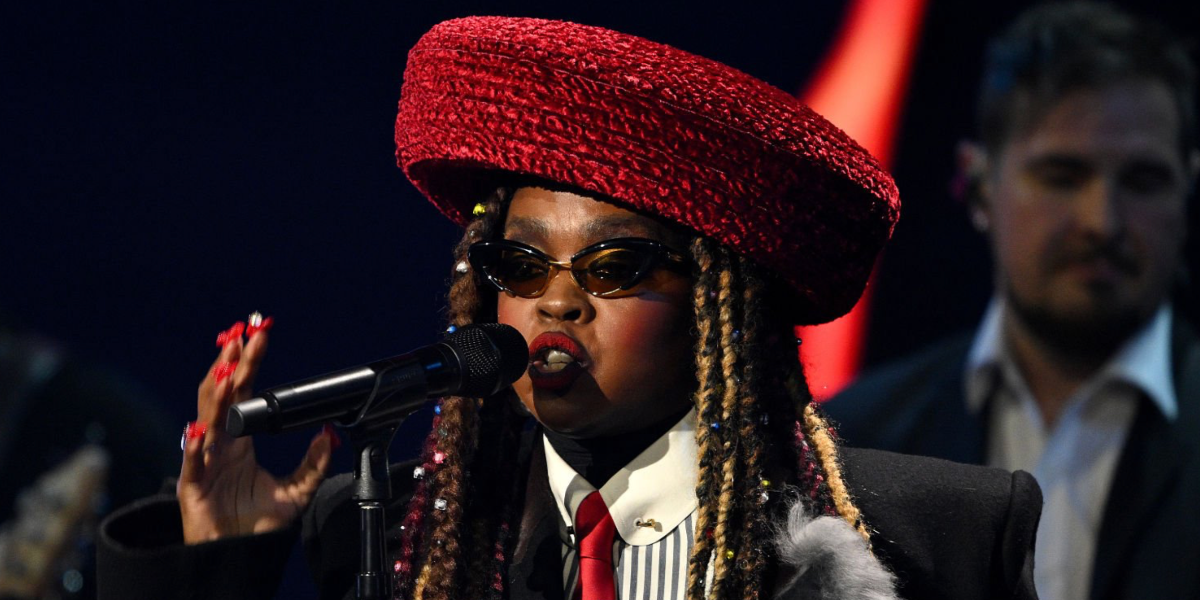 Lauryn Hill was seen wearing black Bottega Veneta BV1387S 001 cat eye sunglasses with yellow lenses onstage at the FIFA World Cup 2026 Official Draw in Washington DC, December 2025