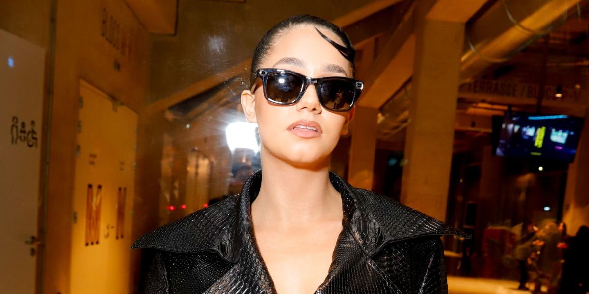 French influencer Lena Mahfouf also known as Lena Situations was seen wearing Ray-Ban Meta x Coperni Wayfarer RW4006S 66506G Limited Edition smart glasses at the Coperni Fall/Winter 2025 fashion show during Paris Fashion Week