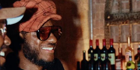 Singer Leon Bridges was seen wearing black Tom Ford Achilles TF1182 05E sunglasses with persimmon Photochromic lenses in London, shared through his Instagram post in July 2026.