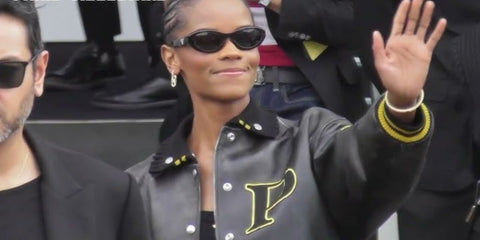 Letitia Wright wears Prada PR 26ZS 16K08Z sunglasses to the brand's Spring/Summer 2025 fashion show in Milan