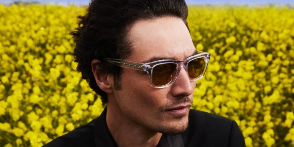 Levi Dylan was seen wearing transparent Oliver Peoples Birell Sun OV5524SU 1692/BH sunglasses with green gradient lenses in the Oliver Peoples Summer 2023 campaign