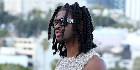 Lil Nas X was seen wearing black Versace 4425U GB1/87 sunglasses at the Versace Fall 2023 fashion show in Hollywood, California