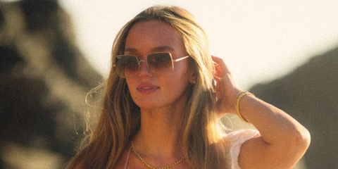 Actress Lilah Pate was seen wearing gold Ray-Ban Square RB 1971 9147/51 sunglasses with brown gradient lenses in a social media post.