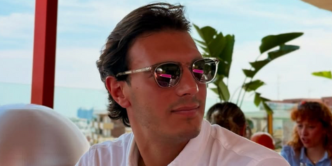 Love Island UK winner Lorenzo Alessi was seen wearing transparent Saint Laurent Sun SL 28 Slim 006 sunglasses with grey lenses in his Instagram post, November 2025.