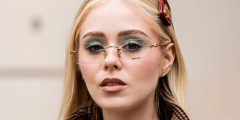 Mexican actress Loreto Peralta was seen wearing gold Miu Miu MU 50YV 5AK1O1 rimless optical glasses at the Miu Miu Spring/Summer 2026 fashion show during Paris Fashion Week.