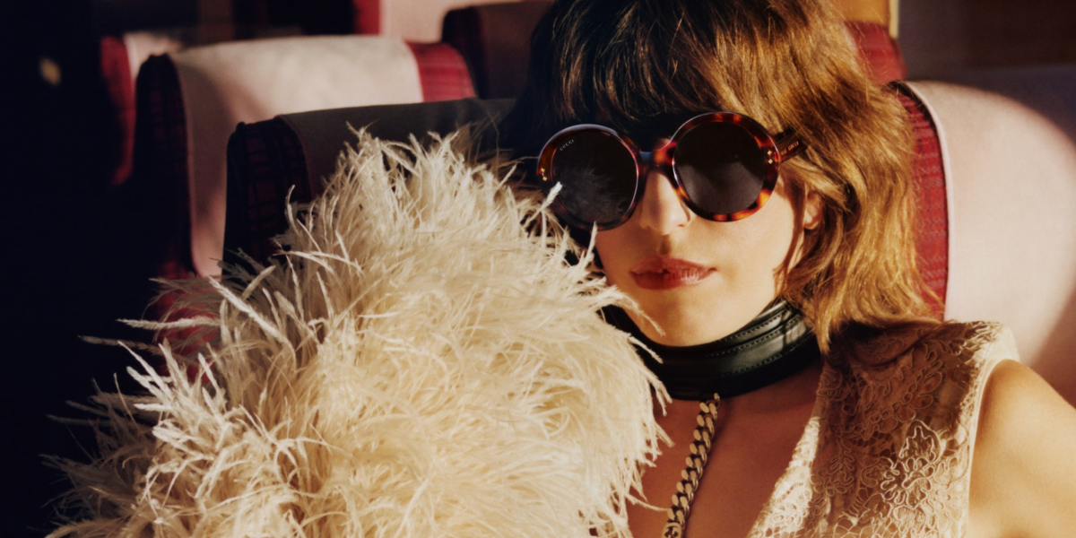 Lou Doillon was seen modeling red brown tortoiseshell Gucci GG1081S 002 round sunglasses with dark grey lenses in the Gucci Eyewear 2022 campaign inspired by the life of musicians on tour