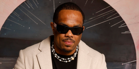 Comedian Lou Young III was seen wearing black Prada PR A01S 16K08Z sunglasses at the Sundance Film Festival 2026.