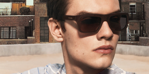 Louis Partridge was seen wearing brown Prada PR D11S 27I90W square sunglasses in the Prada Spring/Summer 2026 campaign.