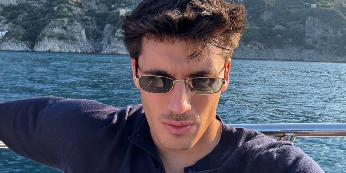 Italian entrepreneur and digital creator Luca Santeramo was seen wearing gold Prada PR B54S 5AK40K rectangular sunglasses with blue lenses in Amalfi Coast, shared through his Instagram post in July 2025.