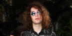 Mick Jagger's son Lucas Jagger was seen wearing transparent Saint Laurent Sun SL 28 012 sunglasses with silver mirror lenses at the Amiri Menswear fashion show during Paris Men's Fashion Week