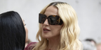 Madonna was seen wearing tortoiseshell Saint Laurent Sun Blaze SL M119 002 sunglasses at the Saint Laurent Menswear Spring/Summer 2027 fashion show during Paris Men's Fashion Week.