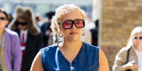 Singer-songwriter Mahalia was seen wearing black Loewe x Paula's Ibiza LW40064U 01Y sunglasses with red lenses during London Fashion Week season Spring/Summer 2025.