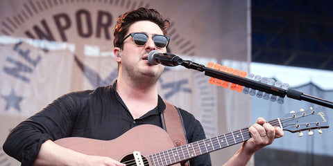 Marcus Mumford was seen wearing the iconic Ray-Ban Clubmaster 3016 W0365 Black half-rim sunglasses onstage at the Newport Folk Festival 2018