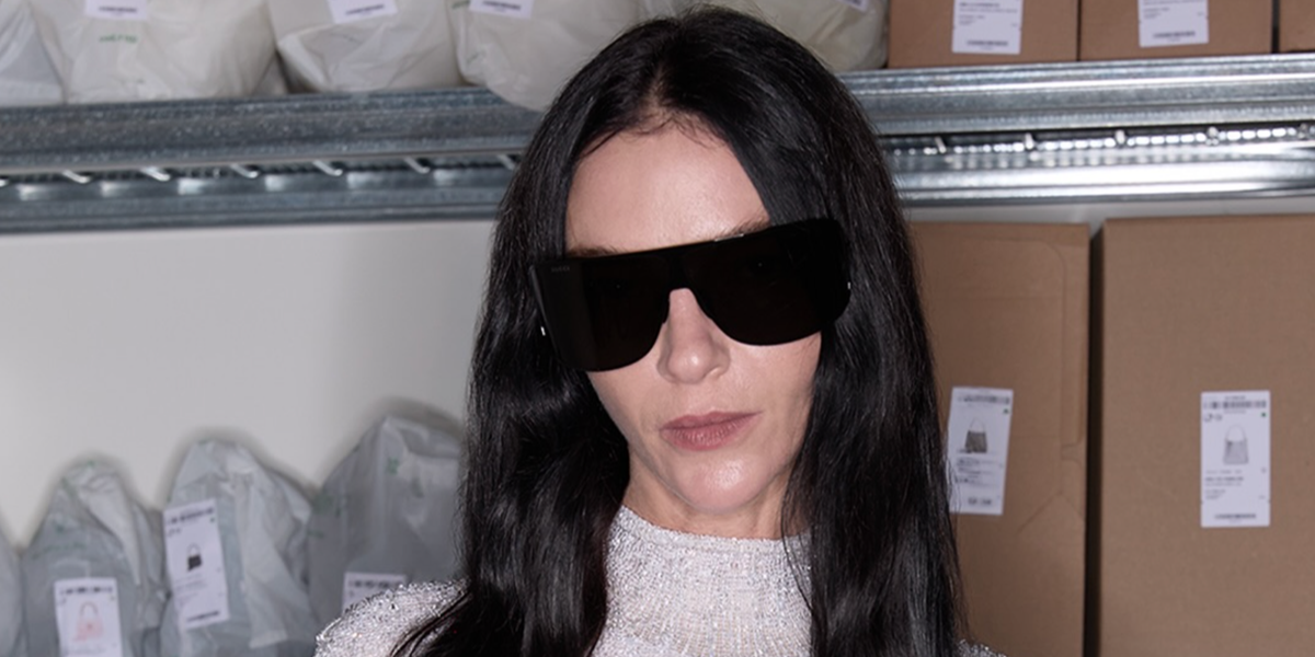 Italian model Mariacarla Boscono wore black Gucci GG2276S 001 shield sunglasses at the Gucci Spring/Summer 2027 show during Milan Fashion Week.