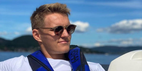 Norwegian footballer Martin Odegaard was seen wearing beige Ray-Ban RB 2180 6166/13 Round sunglasses with brown gradient lenses in a social media post. Shop online now on Pretavoir