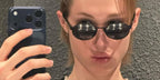 South Korean singer Martin of K-Pop group CORTIS was seen wearing black Prada PR B56S AAV08 round oval sunglasses in his Instagram post, February 2026.