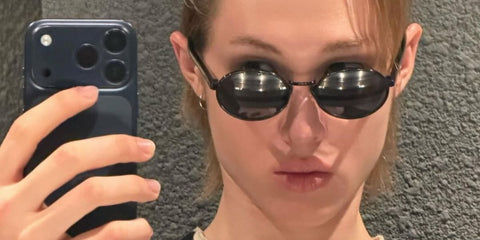 South Korean singer Martin of K-Pop group CORTIS was seen wearing black Prada PR B56S AAV08 round oval sunglasses in his Instagram post, February 2026.