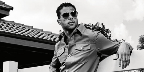 Mason Gooding was seen wearing gold Oliver Peoples Dresner OV1320ST 5292/BH aviator square sunglasses with green gradient lenses in a Hunger Magazine feature, March 2025