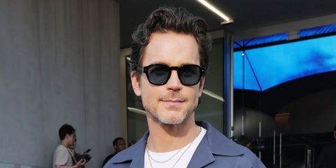 Matt Bomer was seen wearing black Prada PR A16S 16K04D Polarised square sunglasses with blue green lenses to attend the brand's Spring/Summer 2025 menswear fashion show during Milan Men's Fashion Week