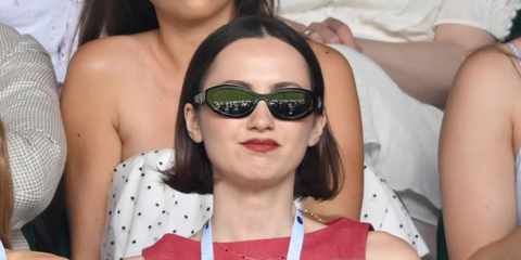 Maude Apatow was seen wearing black Prada PR 26ZS 16K08Z cat eye sunglasses on Day One Wimbledon Tennis Championships 2026