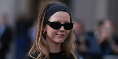 Mia Goth is seen wearing Miu Miu MU 06YS 1AB5S0 sunglasses to the brand's Fall/Winter 2024 fashion show in Paris