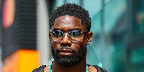 Micah Richards was seen wearing grey on transparent Ray-Ban Hawkeye RB 2298 1355/3F sunglasses with grey to clear gradient lenses at the F1 Great Britain Grand Prix 2025. Shop online now on Pretavoir