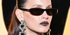 Spanish actress Milena Smit was seen wearing black Saint Laurent Sun SL 557 Shade 001 sunglasses at the Saint Laurent Fall/Winter 2024 fashion show during Paris Fashion Week