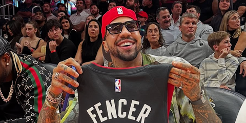 Fencing champion Miles Chamley-Watson was seen wearing black and gold Dita Detron DTS 459 01 sunglasses at the Miami Heat arena