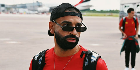 Mohamed "Mo" Salah was seen wearing black Tom Ford Alejandro TF1058 01A rectangular sunglasses as he headed to the US in July 2024, on the official Liverpool FC Tweet / X post