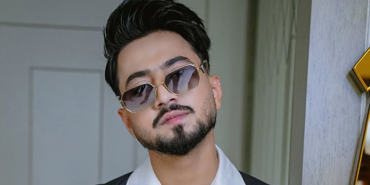 Indian content creator Faisal Shaikh, widely known as Mr. Faisu, was seen wearing gold Prada PR A51S ZVN50C sunglasses with brown gradient lenses in his Instagram post, June 2025. Shop online now on Pretavoir