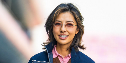 Professional golfer Muni He was seen wearing gold Miu Miu MU A54S ZVN70O rimless oval sunglasses with pink gradient lenses at the F1 Chinese Grand Prix 2025.