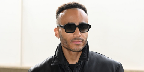 Actor and comedian Munya Chawawa was seen wearing black Prada PR 02ZS 1AB06T square sunglasses with grey gradient lenses during London Fashion Week season Fall/Winter 2025.