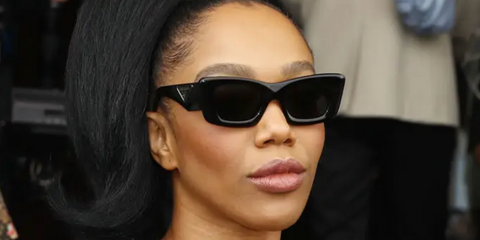 Naomi Ackie was seen wearing black Prada PR 13ZS 1AB5S0 cat eye sunglasses to attend the brand's Fall/Winter 2023 fashion show during Milan Fashion Week