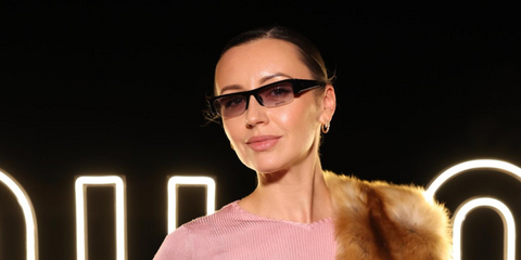 Creative director and travel influencer Nataly Osmann was seen wearing black Miu Miu MU B07S 16K04O sunglasses with grey gradient lenses at the Miu Miu Select event in Dubai, November 2025.