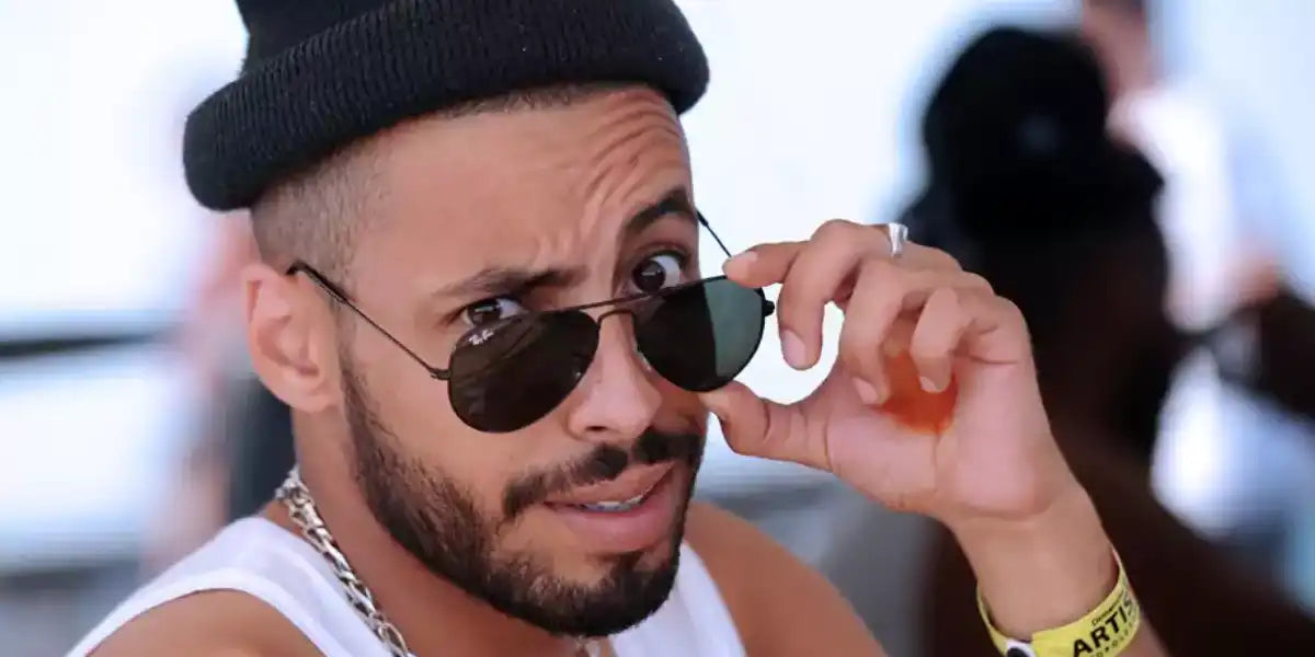 French rapper Nemir was seen wearing Ray-Ban Aviator RB 3025 L2823 Black/Green sunglasses at the Francofolies music festival in 2013