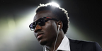Australian footballer Nestory Irankunda was seen wearing shiny black Prada Linea Rossa SPS 06Y 1AB09U square sunglasses with grey gradient lenses at the FIFA World Cup 2026
