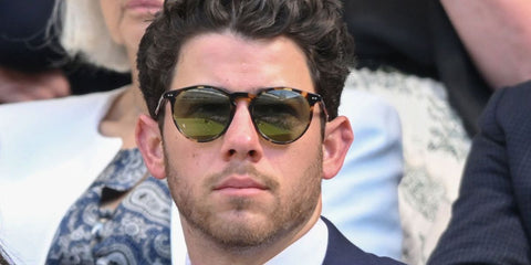 Nick Jonas was seen wearing tortoiseshell Ralph Lauren RL8181P 5249/4E round sunglasses with green lenses at the Wimbledon Tennis Championships 2025. Shop online now on Pretavoir