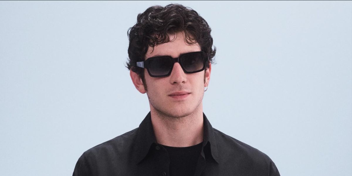 Italian actor Nicolas Maupas was seen wearing black Prada PR 02ZS 1AB06T sunglasses with grey gradient lenses at the Prada Menswear Spring/Summer 2025 fashion show during Milan Men's Fashion Week.
