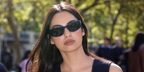 Digital creator and internet personality Nicole Sahebi wore blue Miu Miu MU C06SU 22N51A wraparound sunglasses at the Miu Miu Spring Summer 2027 show during Paris Fashion Week.