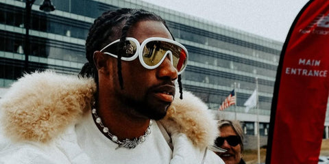 Noah Lyles was seen wearing white Loewe x Paulas Ibiza LW40108I 24C sunglasses with gold mirrored lenses at the Boston Indoor Grand Prix, February 2025. Shop online now on Pretavoir