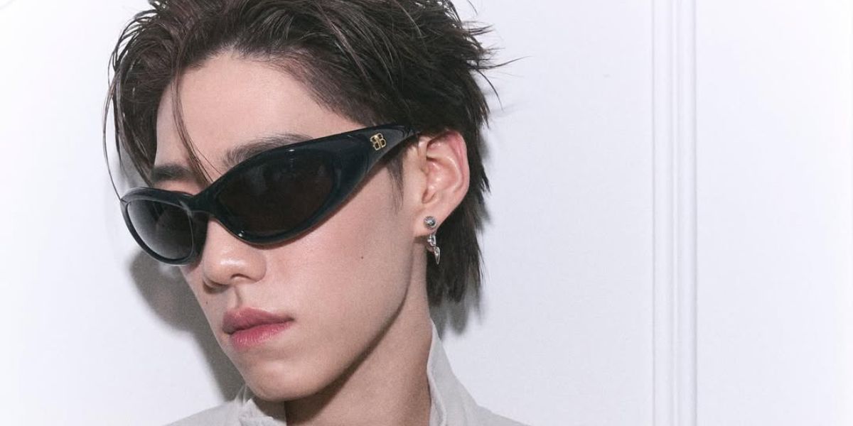 Thai actor and celebrity PP Krit was seen wearing black Balenciaga BB0384SA 001 Asian Fit sunglasses in a Prestige Thailand magazine feature about Balenciaga x Puma collaboration, July 2025.
