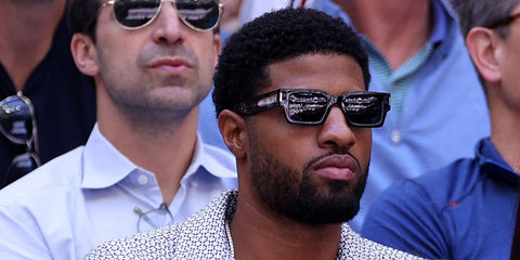 American basketball player Paul Goerge was seen wearing black Saint Laurent SL 572 001 rectangular sunglasses