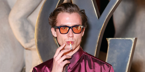 Actor Paul Hameline was seen wearing denim blue Oliver Peoples Oliver Sun OV5393SU 1566/53 sunglasses with cognac brown lenses at the Saint Laurent Fall/Winter 2026 fashion show during Paris Fashion Week.