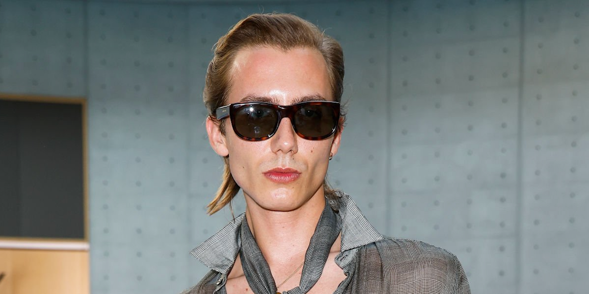 Actor Paul Hameline was seen wearing tortoiseshell Saint Laurent Sun SL 815 Romy 002 sunglasses with green lenses at the Saint Laurent Menswear Spring/Summer 2026 fashion show during Paris Men's Fashion Week.
