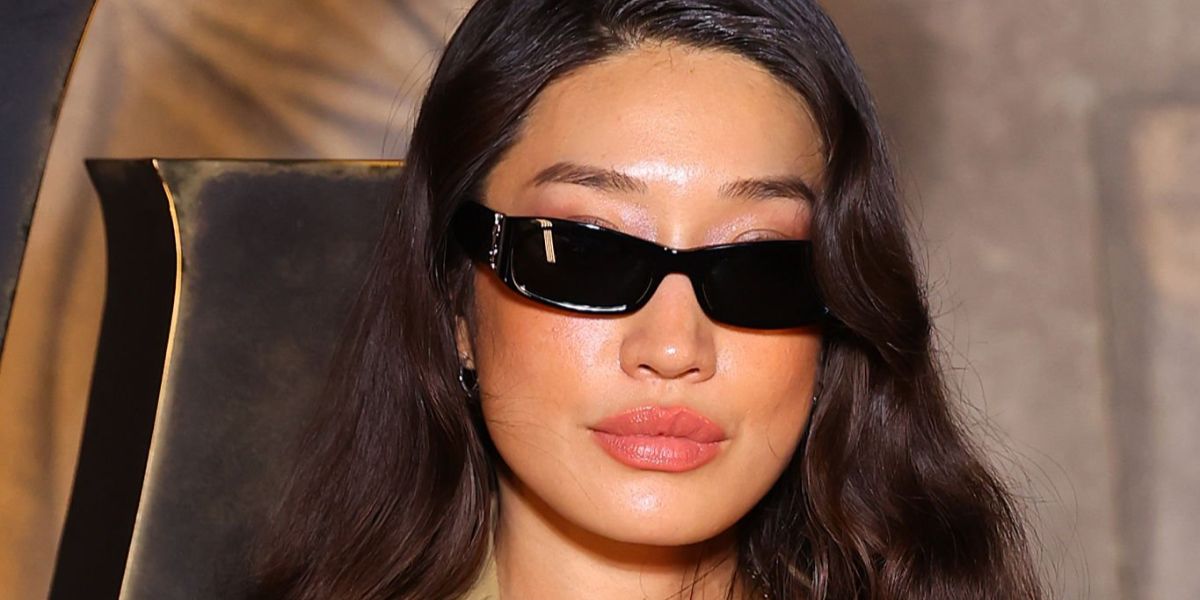 DJ Peggy Gou was seen wearing black Saint Laurent Sun SL M152/F 001 Asian Fit sunglasses at the Saint Laurent Fall/Winter 2026 fashion show during Paris Fashion Week.