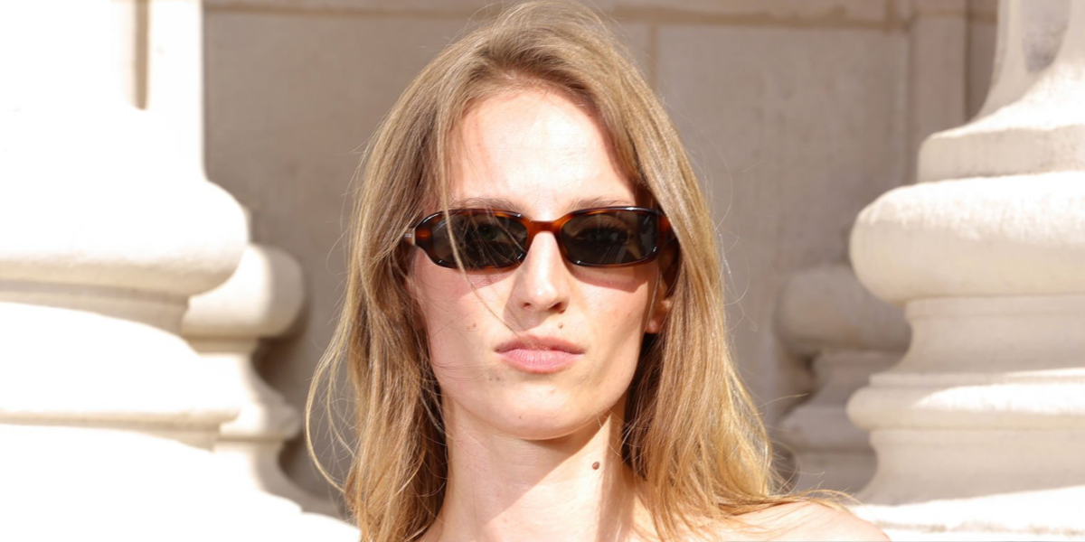 Photographer Petra Collins was seen wearing tortoiseshell Saint Laurent Sun SL 872 Erin 004 sunglasses with grey lenses at the Saint Laurent Menswear Spring/Summer 2027 fashion show during Paris Men's Fashion Week.