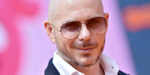 Pitbull was seen wearing gunmetal Ray-Ban RB 3584N 004/13 aviator sunglasses with brown gradient lenses