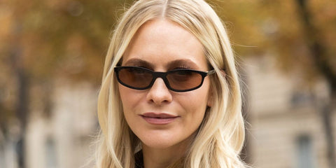 Poppy Delevingne was seen wearing black Miu Miu MU A06S 16K10I sunglasses with brown lenses at the Miu Miu Spring/Summer 2026 fashion show during Paris Fashion Week.