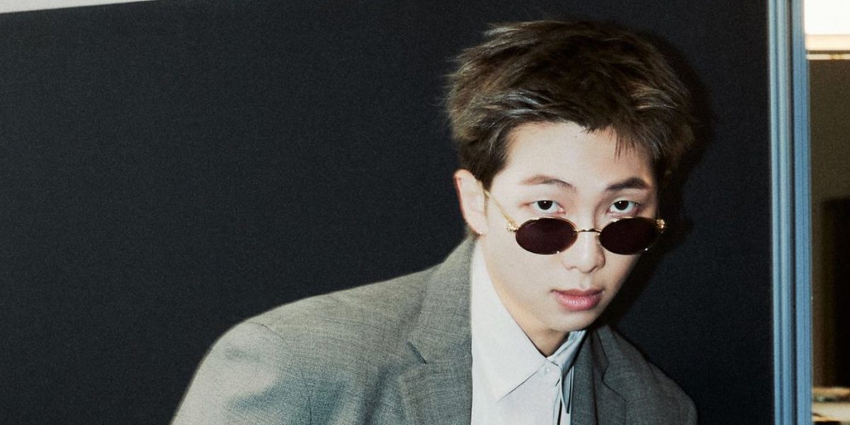RM of BTS was seen wearing gold Clash de Cartier CT0644S 003 oval sunglasses with red lenses in a GQ feature, March 2026, ahead of the BTS Comeback Concert and World Tour Arirang.