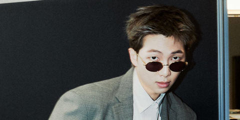 RM of BTS was seen wearing gold Clash de Cartier CT0644S 003 oval sunglasses with red lenses in a GQ feature, March 2026, ahead of the BTS Comeback Concert and World Tour Arirang.